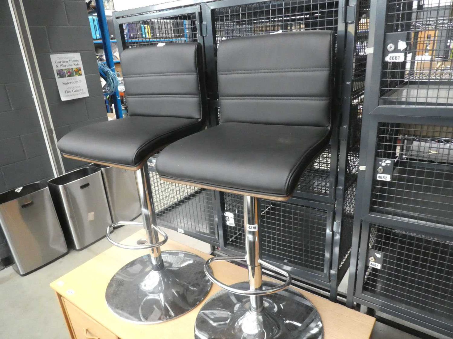 2 black chrome based bar stools