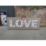 Illuminated sign spelling LOVE