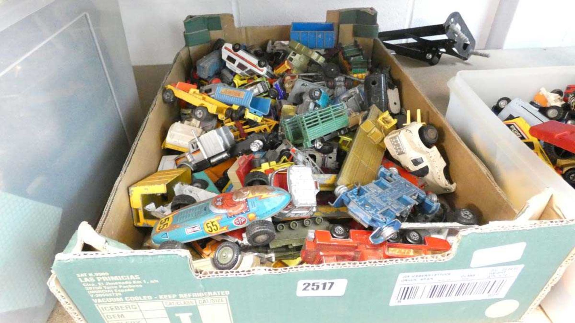 Large cardboard tray containing various die cast vehicles including Dinky and others