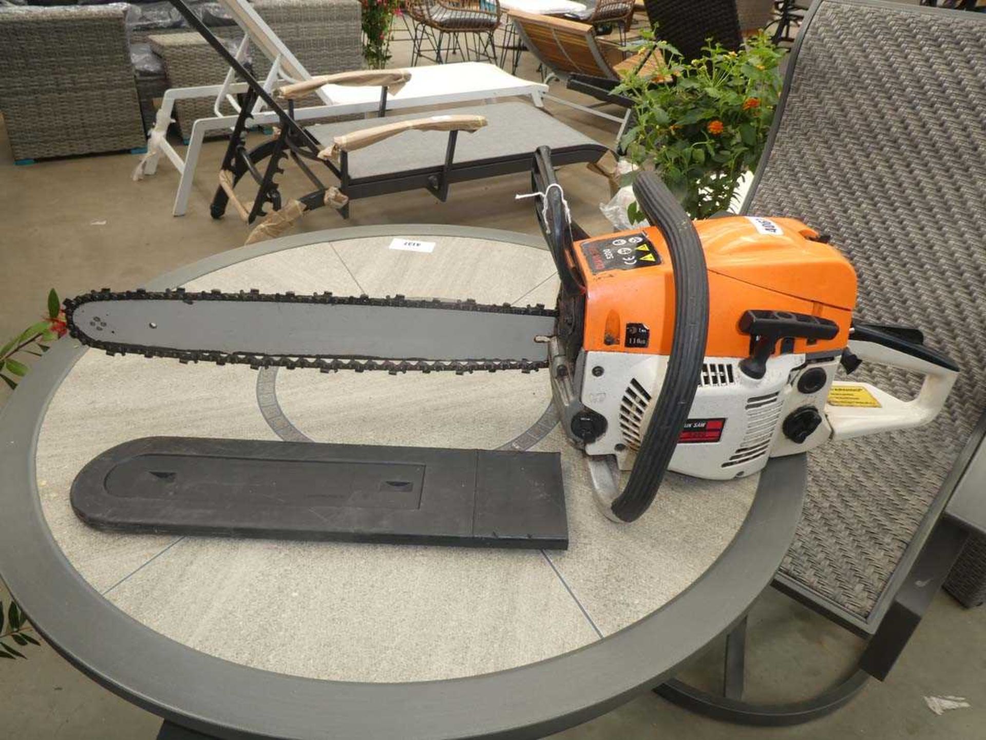 Green and white petrol powered chainsaw
