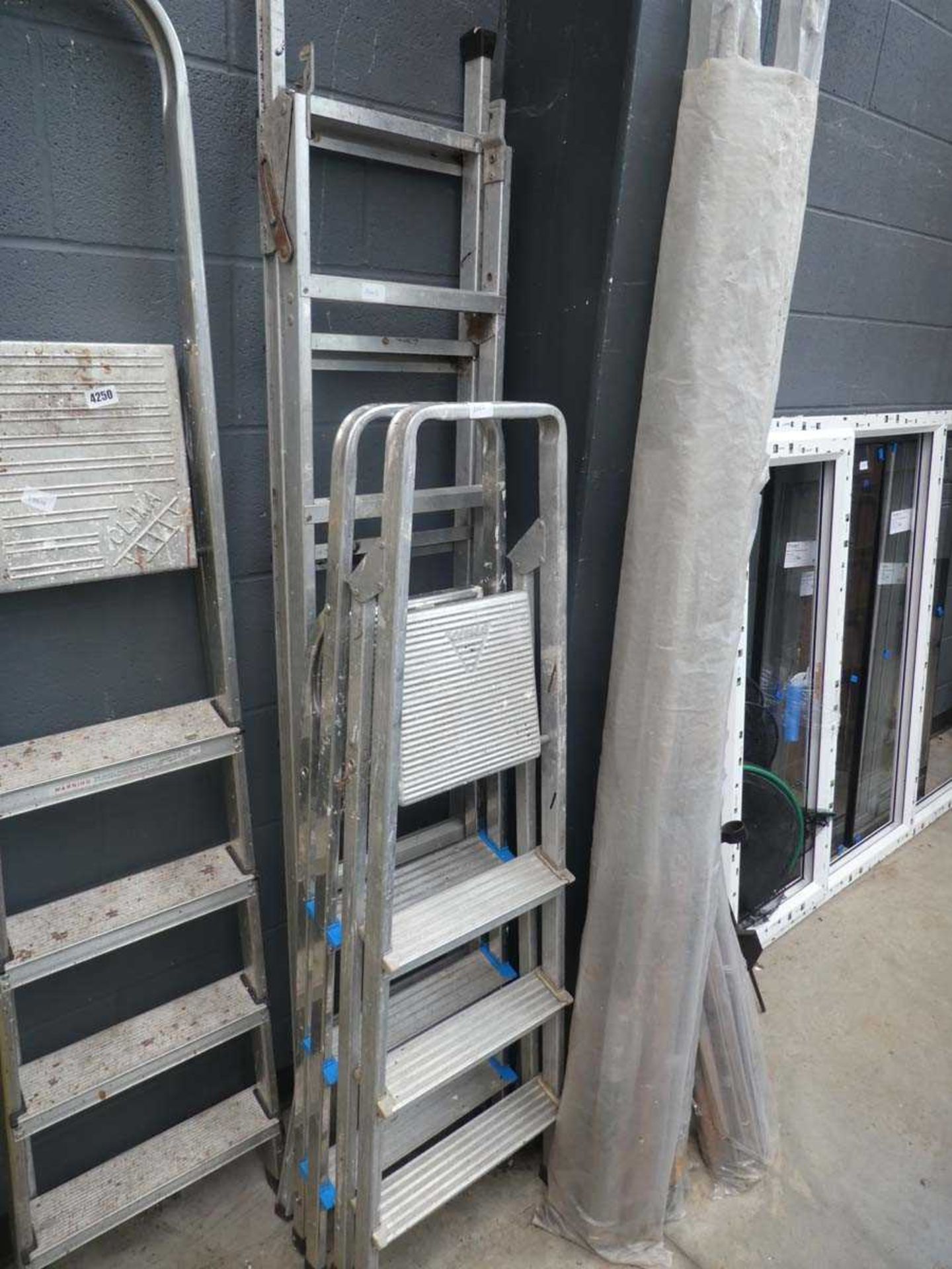 Two four tread aluminium step ladders and a fold out double section ladder