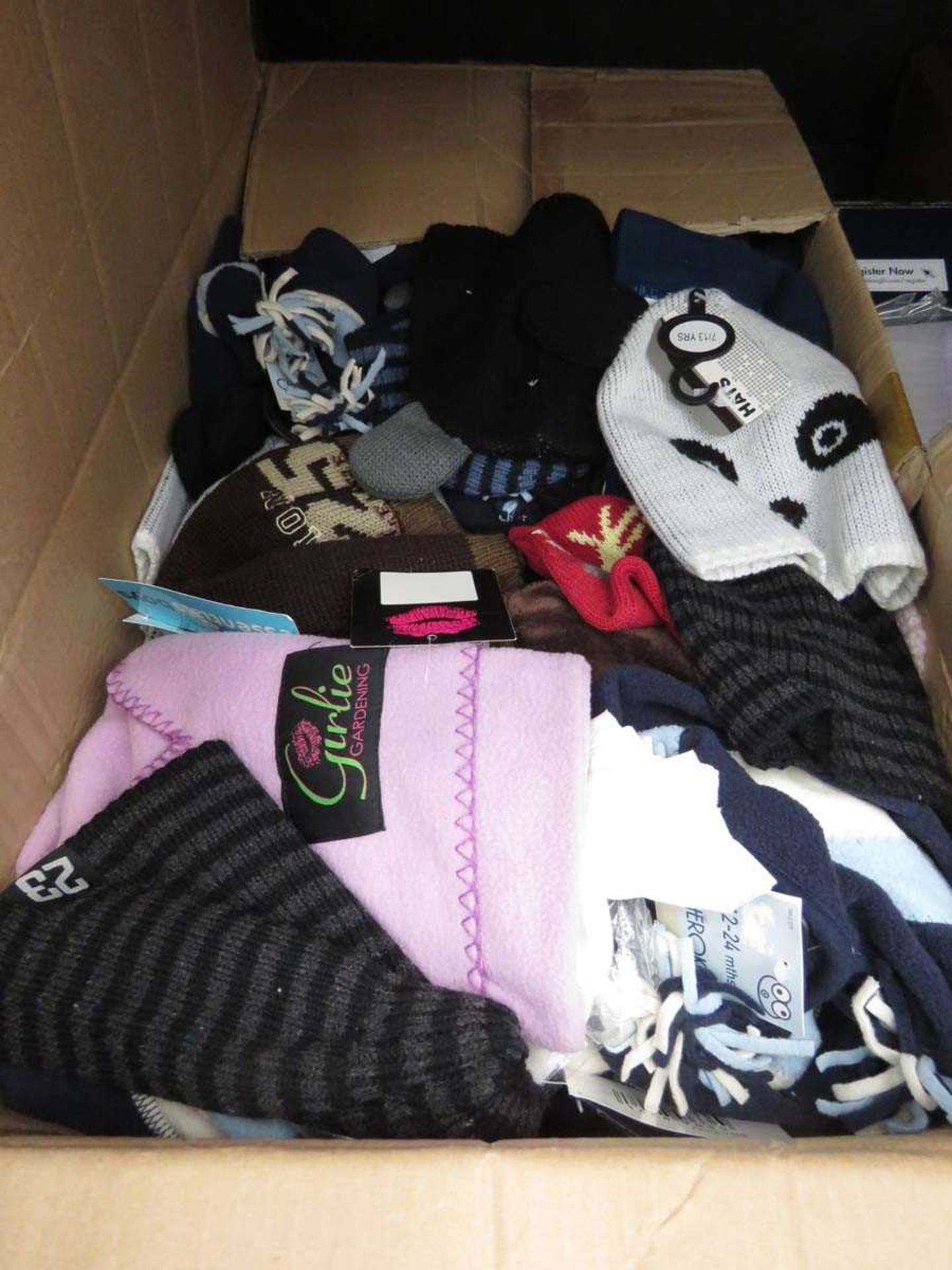 Box containing various woolly hats