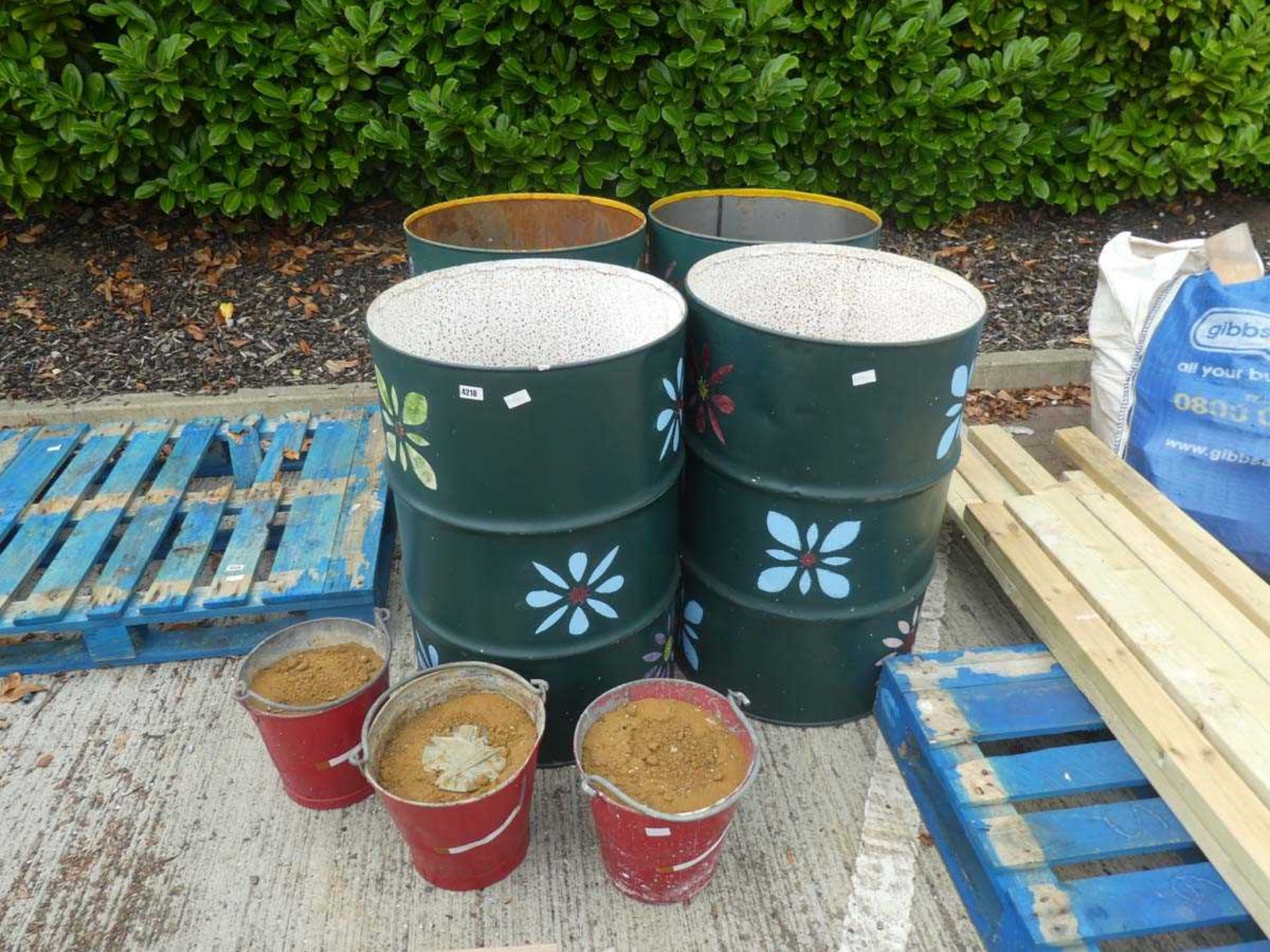 4 painted oil drums and 3 fire buckets