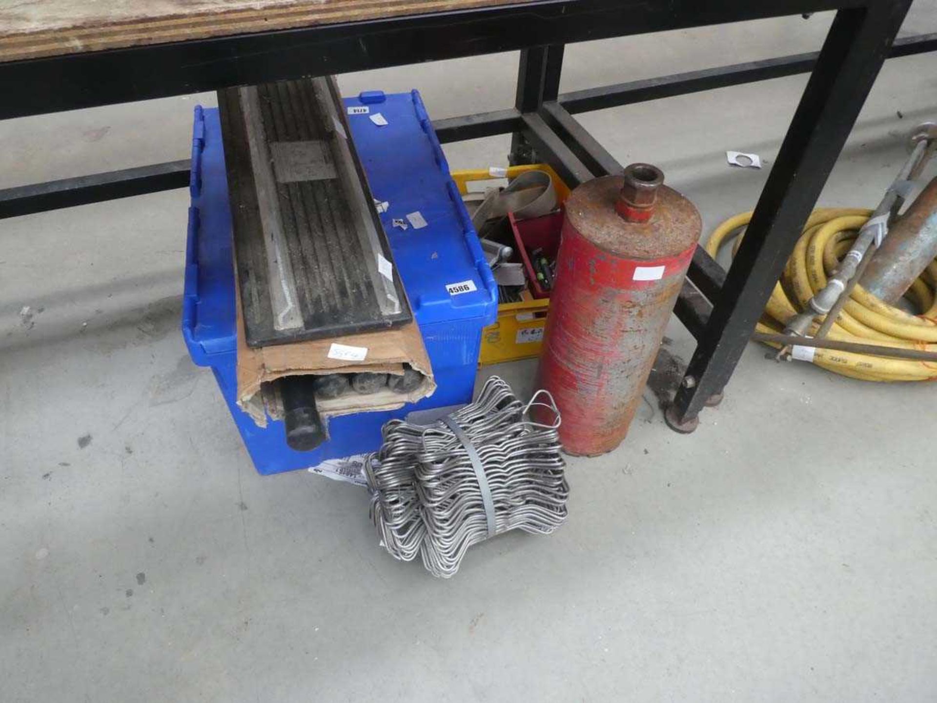 Underbay containing large core-cutter, galvanized clips, ladder stay and various other items