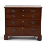 An early 19th century mahogany chest of four graduated drawers, with bone escutcheons and bracket