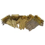 A group of vintage leather gloves with gold thread and sequins, including two pairs and an