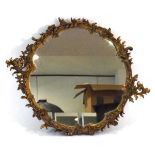 A 19th century giltwood mirror, the circular plate within a foliate surround, overall w. 69