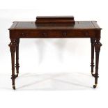 A Victorian walnut writing table, the tooled leather surface surmounted by a fitted desk tidy of