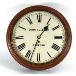 A circular wall clock retailed by John Bull of Bedford, the brass fusee movement within a mahogany
