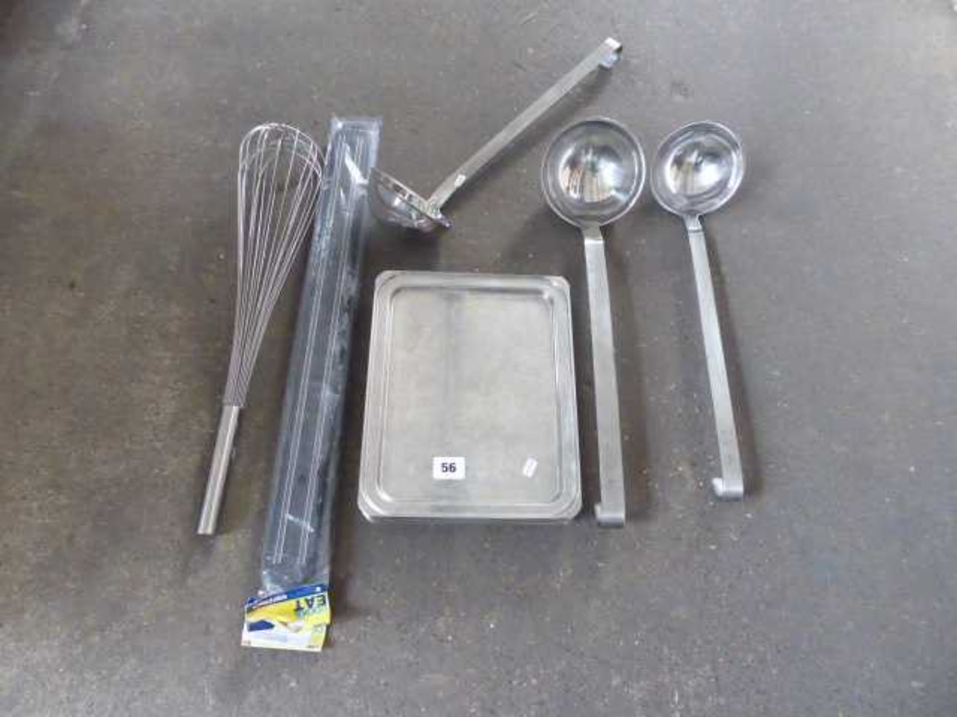 Small stack of trays, large whisk, 3 ladles and 2 magnetic knife racks