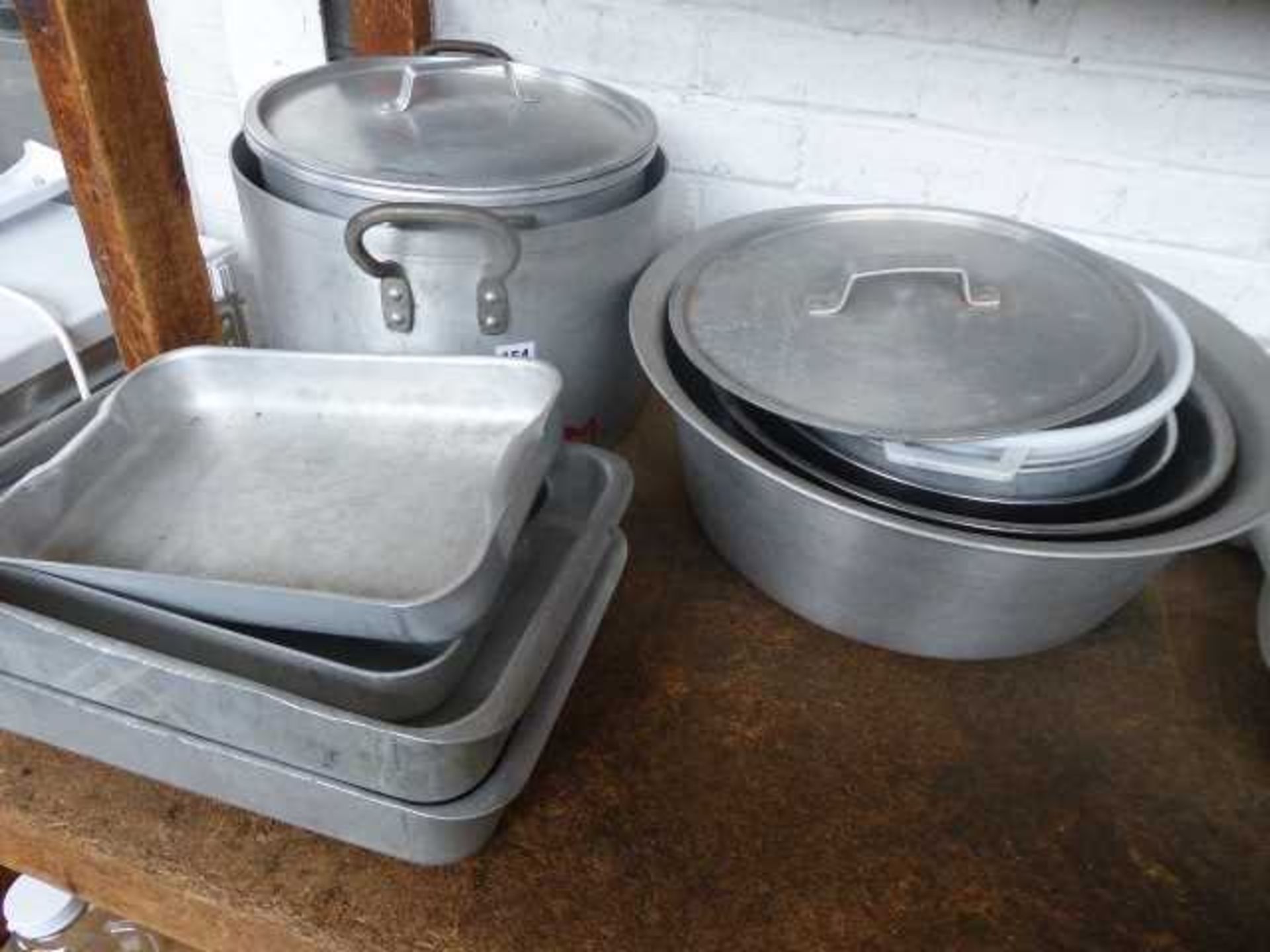 Aluminium cooking pots and pans (some with lids), mixing bowls and baking trays