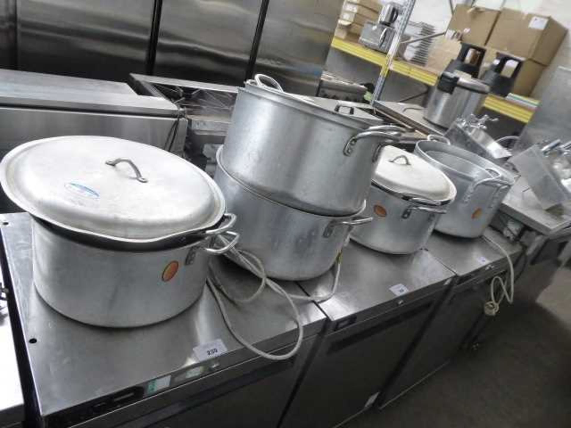 Large quantity of aluminium cooking pots, some with lids