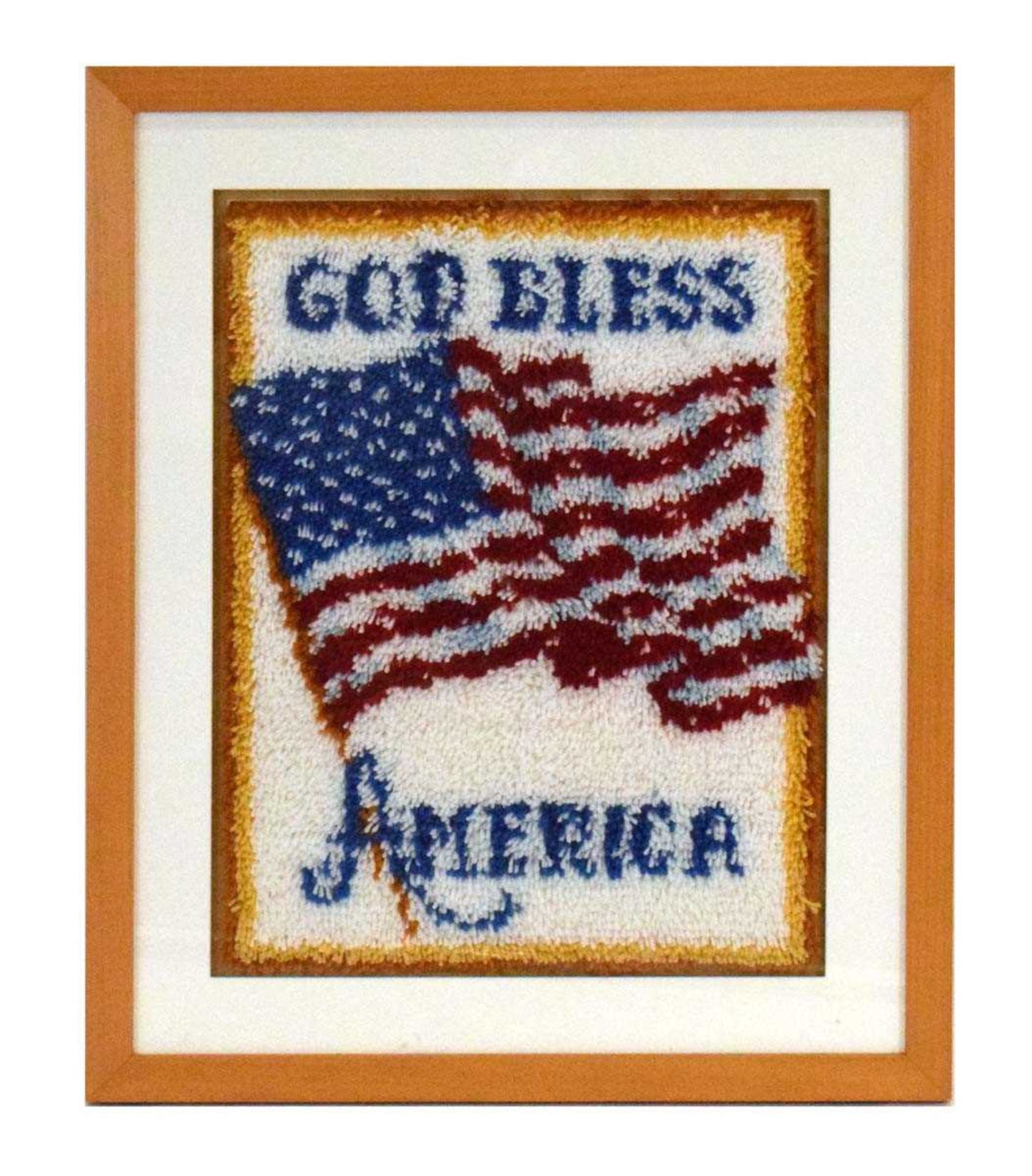 A woollen wall hanging depicting an American flag embossed with the words 'God Bless America', 70
