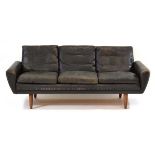 A 1960's Danish black leather three-seater sofa on teak tapering legs*Sold subject to our Soft