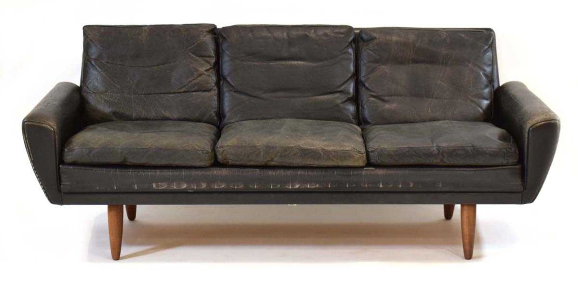 A 1960's Danish black leather three-seater sofa on teak tapering legs*Sold subject to our Soft