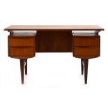 A 1960's Danish teak and crossbanded desk, the surface 'floating' over two pedestals on tapering