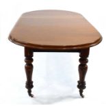 A Victorian mahogany wind-out dining table with a Joseph Fitter Patent mechanism, the oval surface