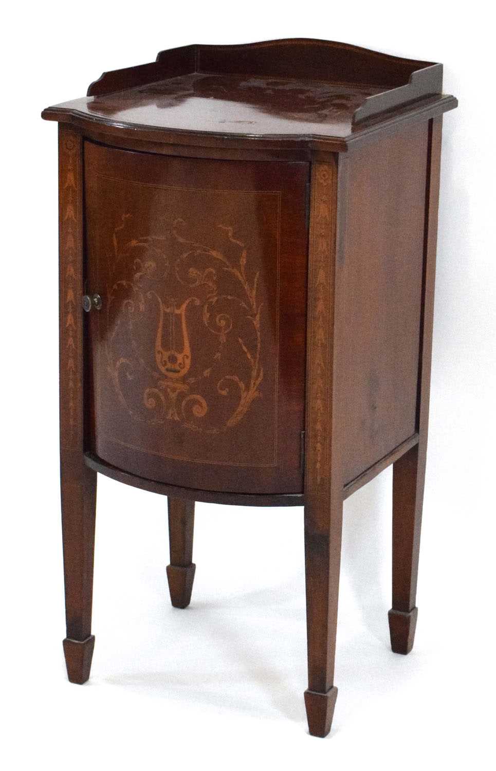 An Edwardian mahogany and marquetry bow-fronted pot cupboard on tapering legs with block feet, w. 40