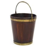 An 18th century mahogany and brass-bound peat bucket, d. 36 cmSlats slightly loose with a few mm gap