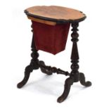 A Victorian walnut sewing table, the serpentine surface supporting a basket below