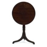A George IV mahogany round dish-top table on a turned column with three splayed legs, d. 58.5 cm
