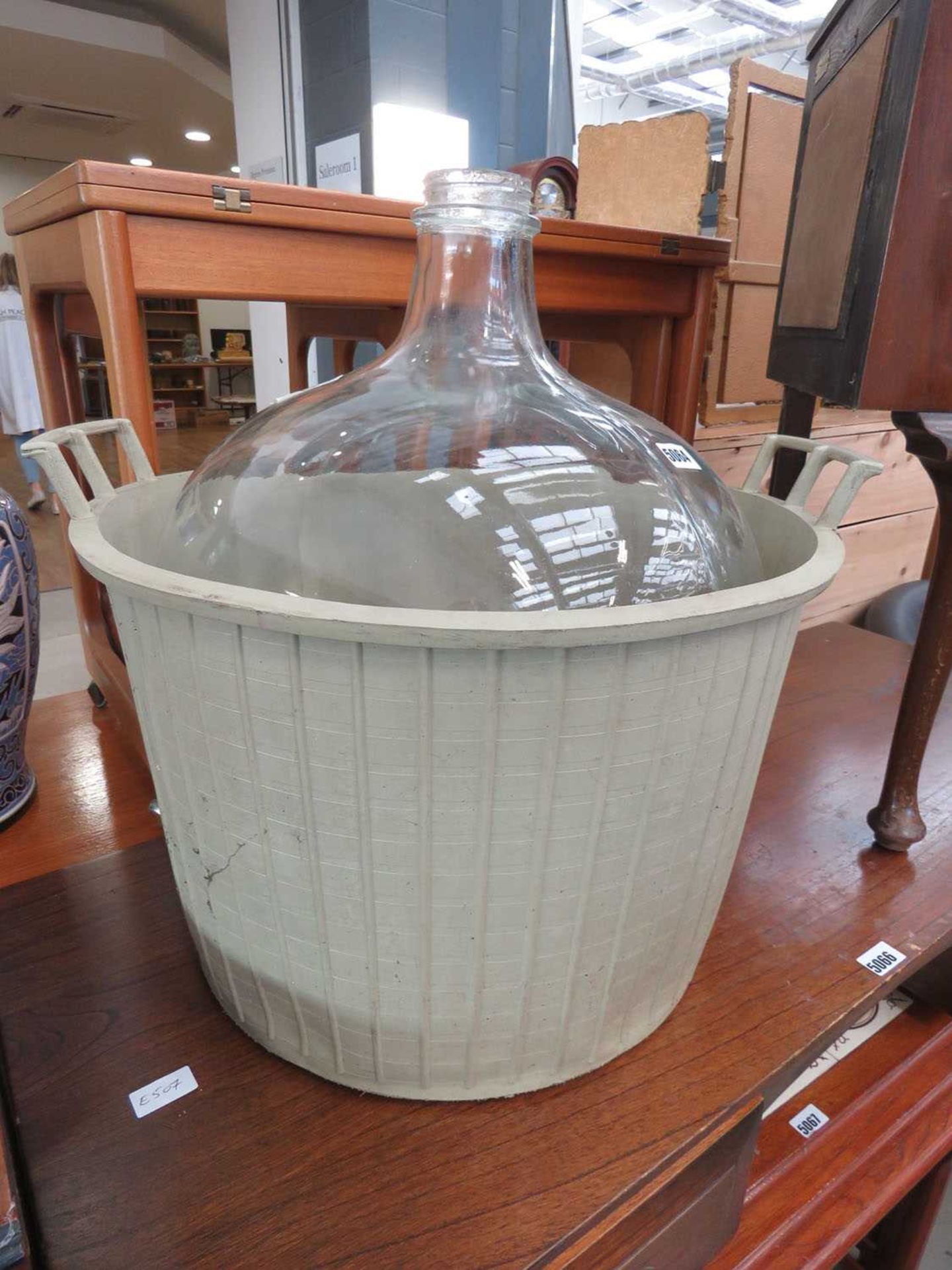 Carboy with plastic basket