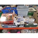Three boxes containing coffee mugs, ornamental figures, glassware, a Race Night DVD game, plus a
