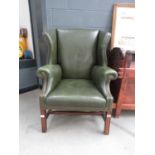 Green leather effect wing back armchair