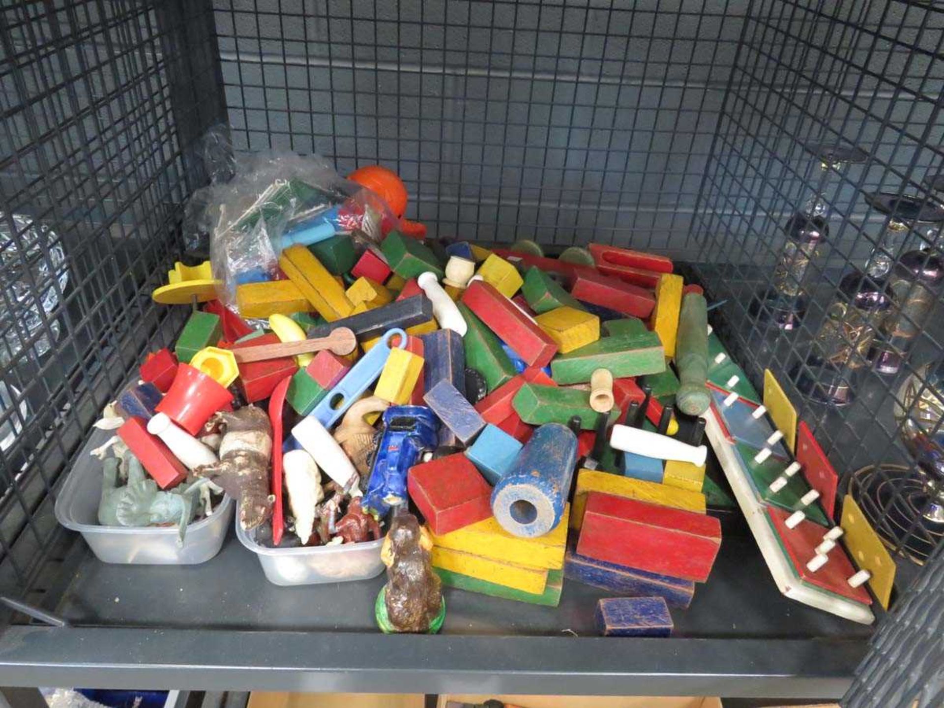 Cage containing a quantity of building blocks and childrens toys