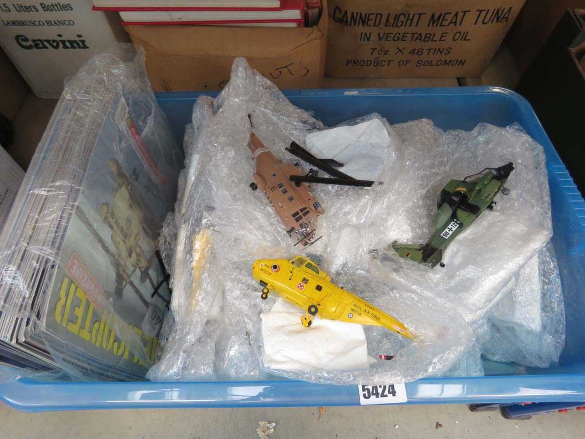 Box containing helicopter magazines and associated toys