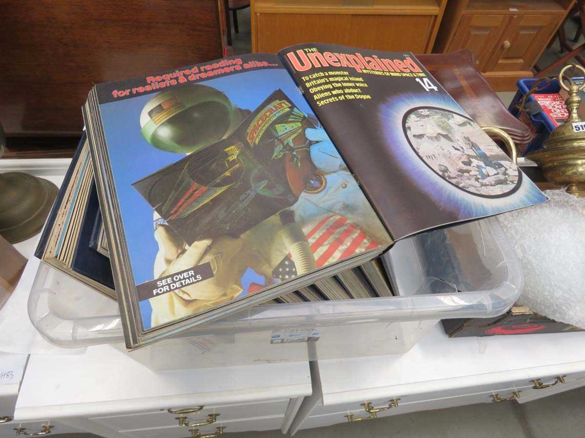 Box containing a quantity of 'The Unexplained' magazines