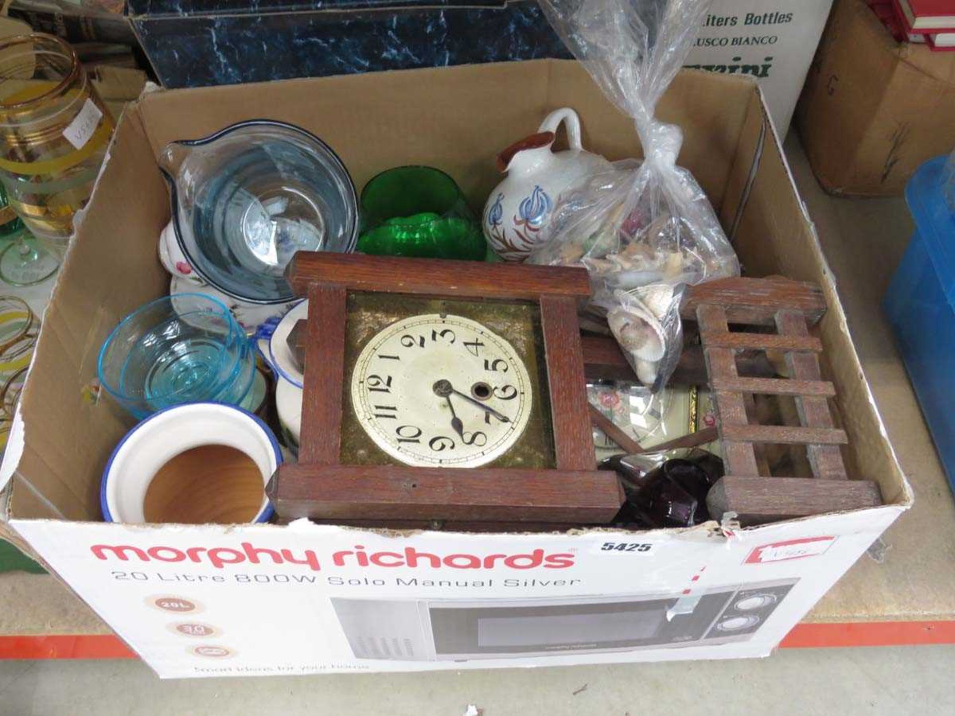 Box containing sea shells, clocks, coffee mugs and glassware