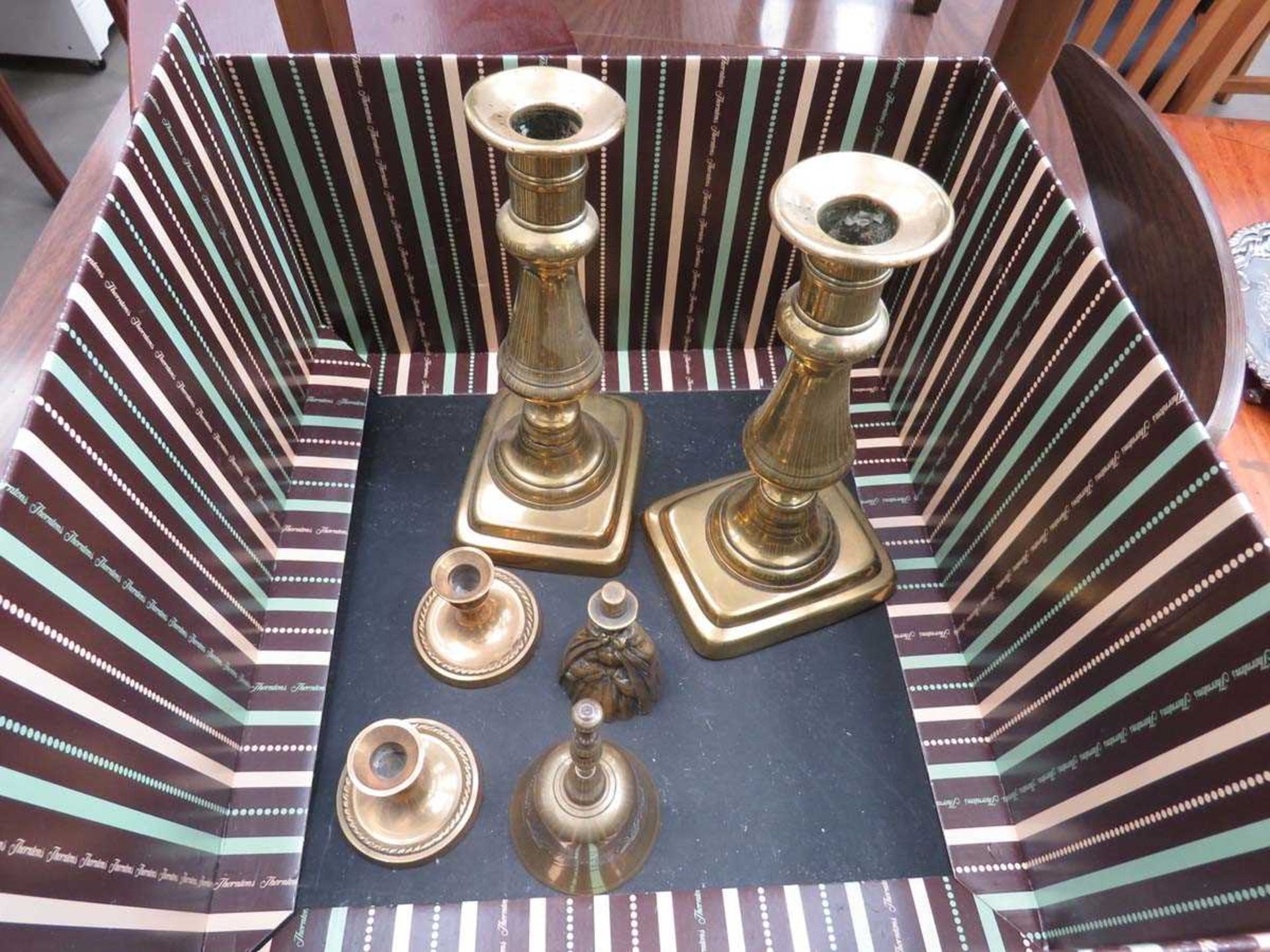 Two pairs of brass candlesticks plus 2 brass bells