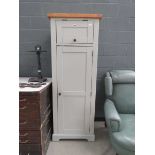 Grey painted single door kitchen cupboard with fitted interior and top box