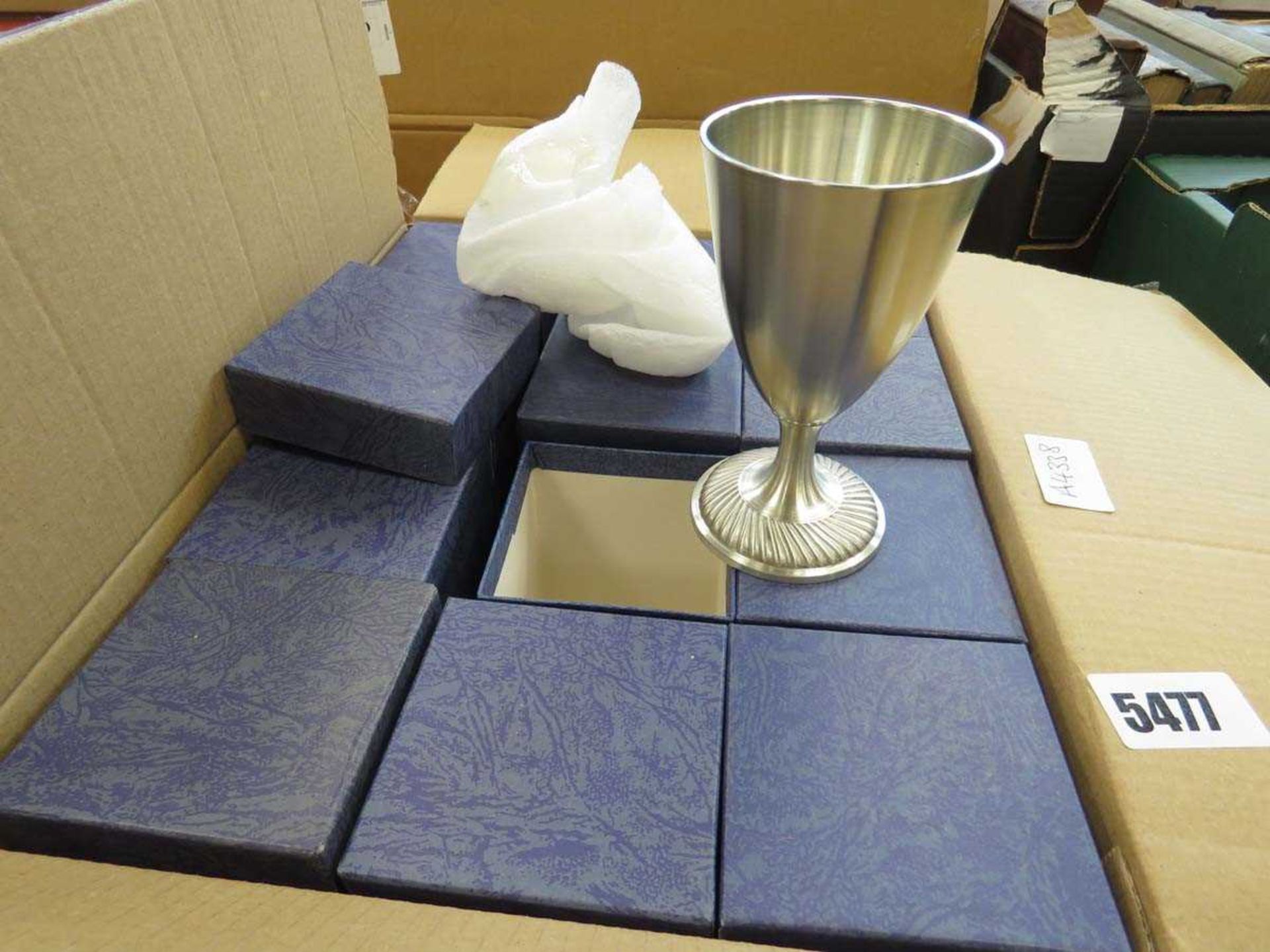 Box containing metal goblets