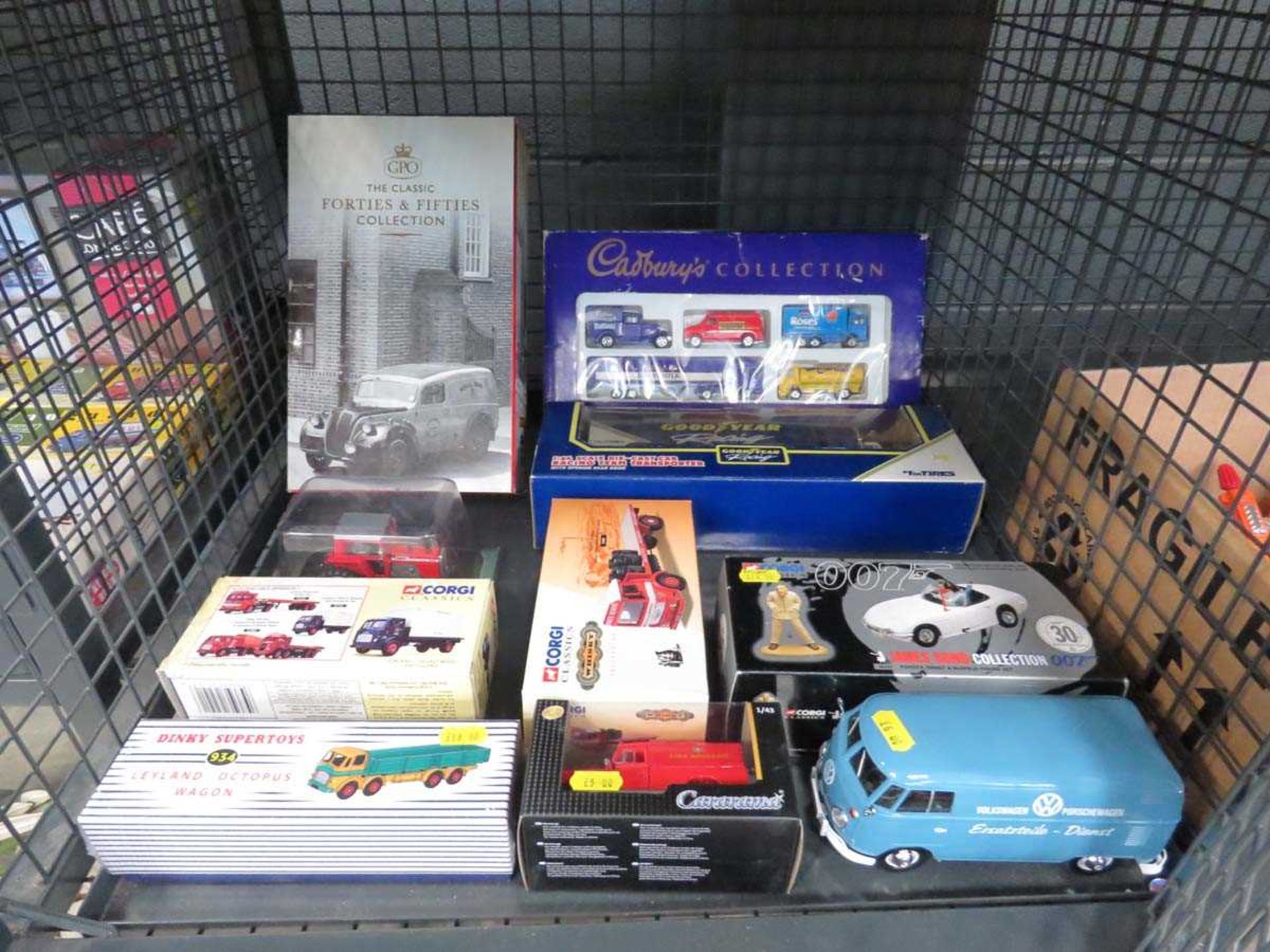 Cage containing a quantity of boxed Corgi and other cars