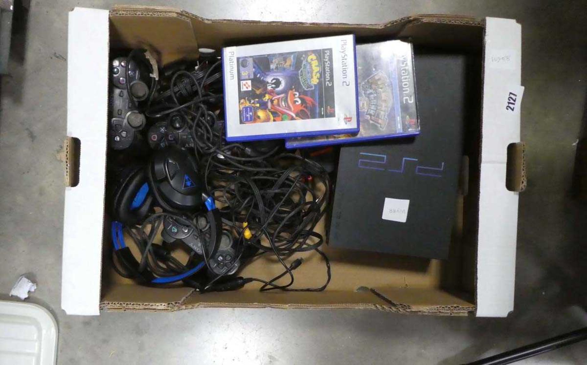 Sony PlayStation 2 console with various accessories and some games