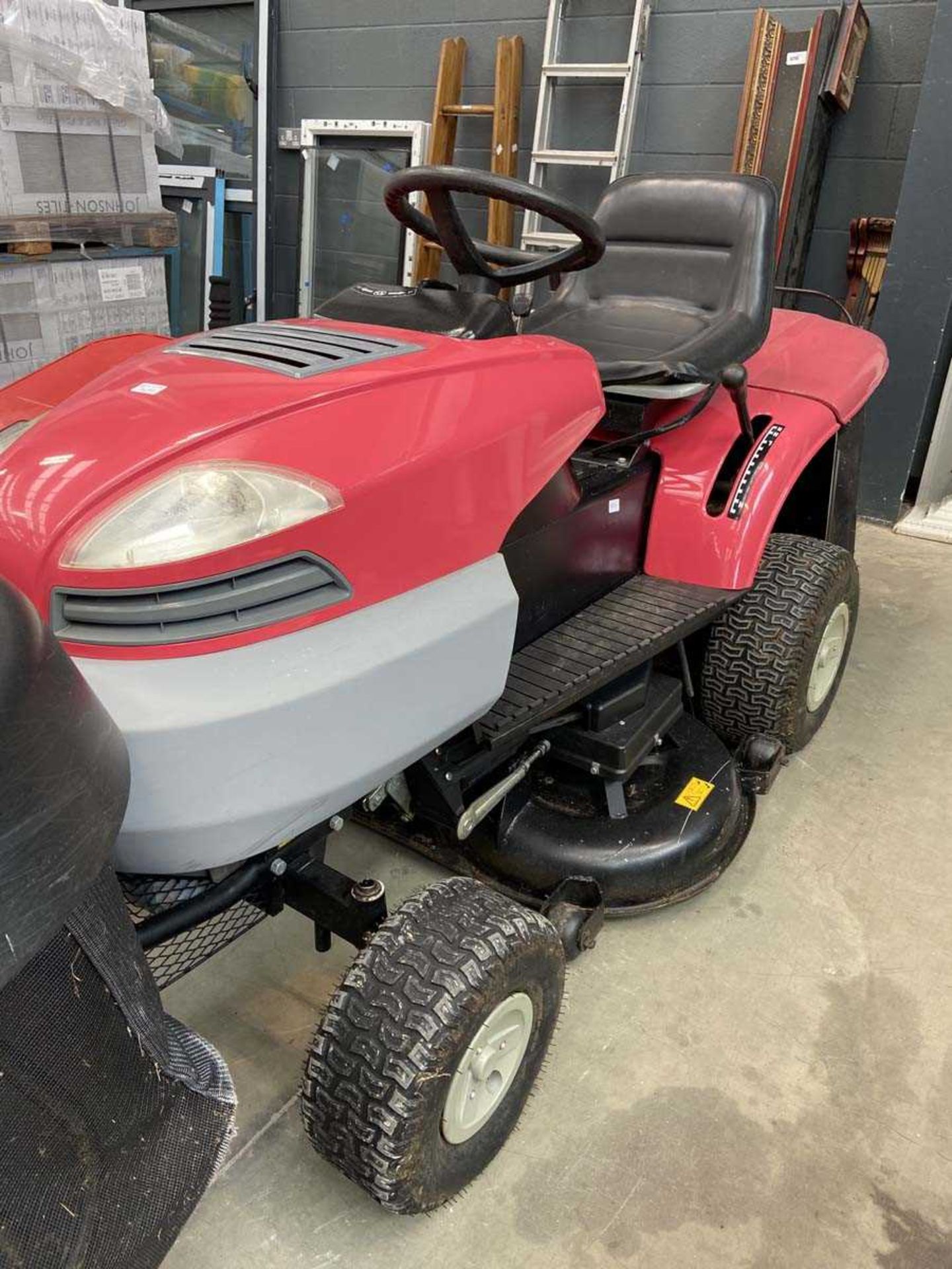 Ride on lawn mower with red grass box