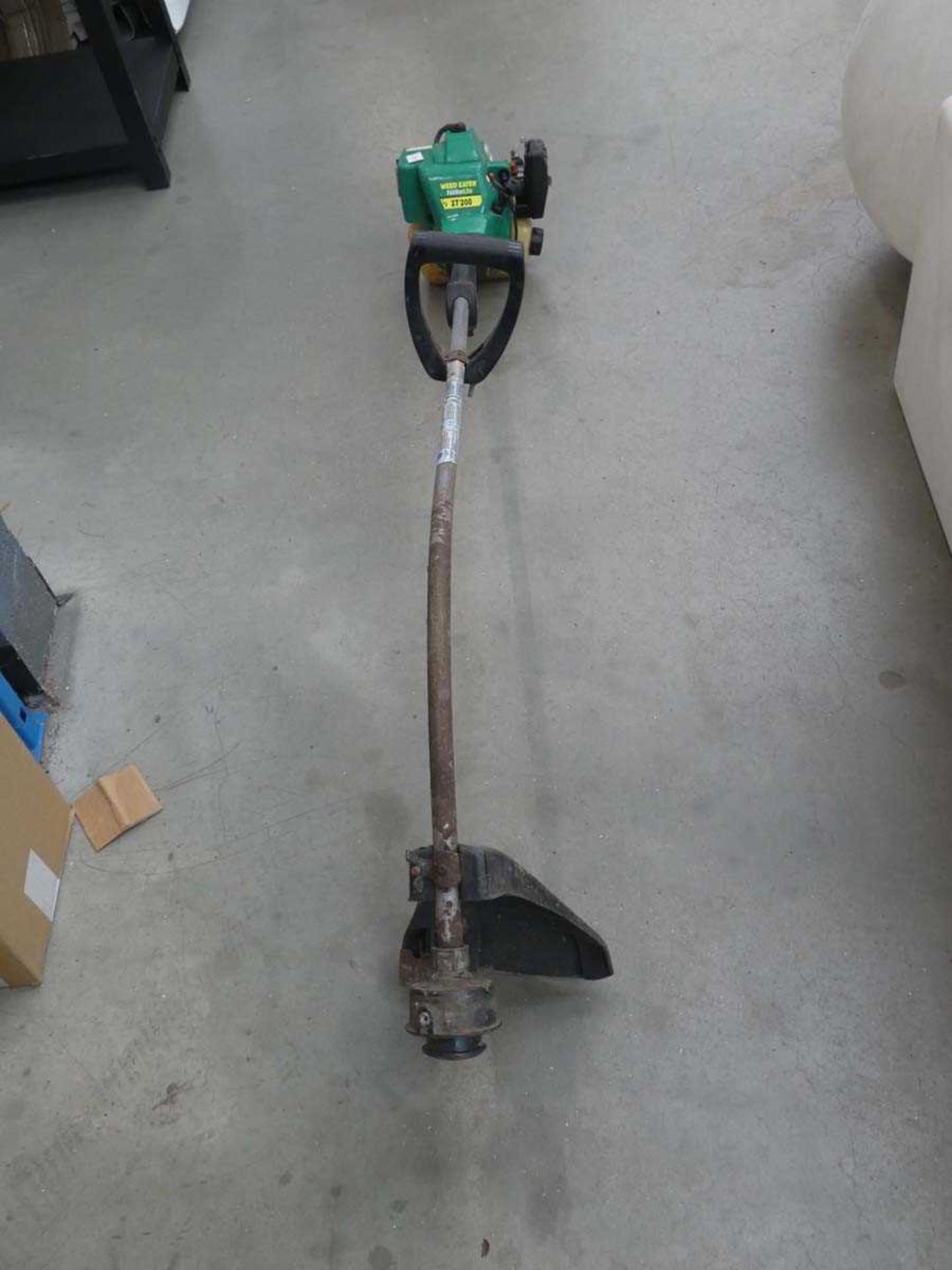 Green petrol engine bent arm strimmer