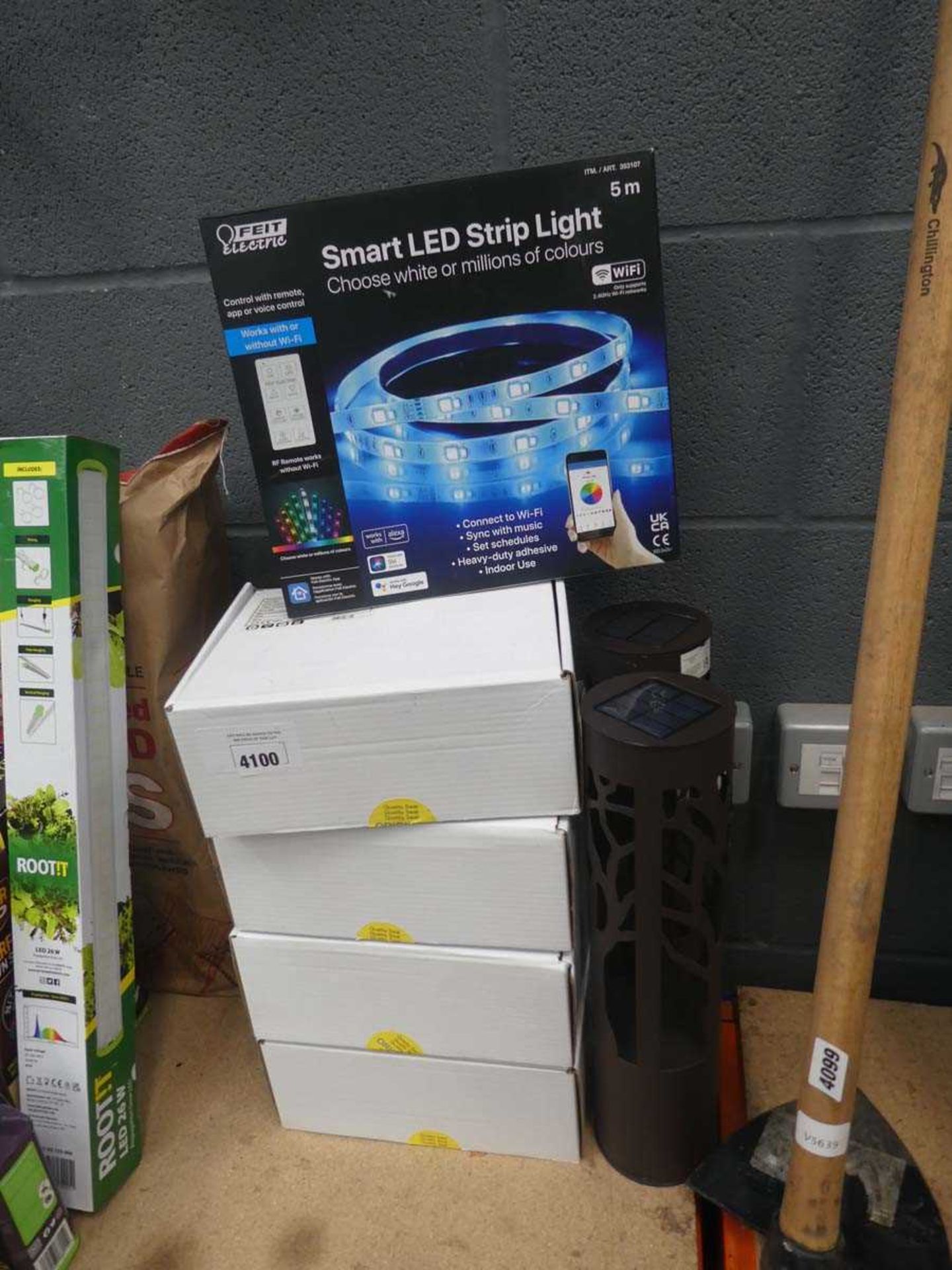 Two solar garden lanterns, four boxes of LED cluster lights and a single box of Feit smart LED strip