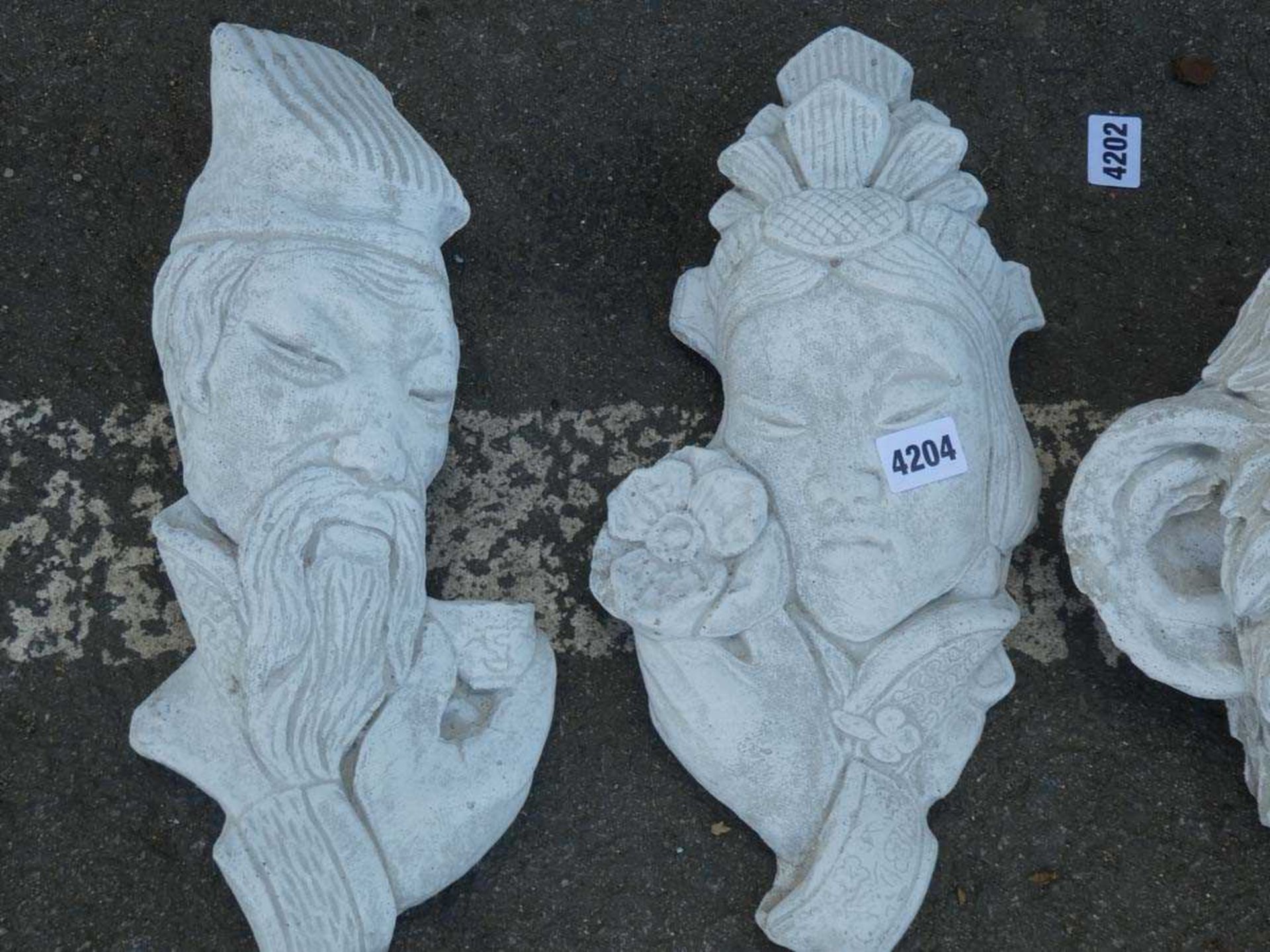 Pair of concrete oriental figures