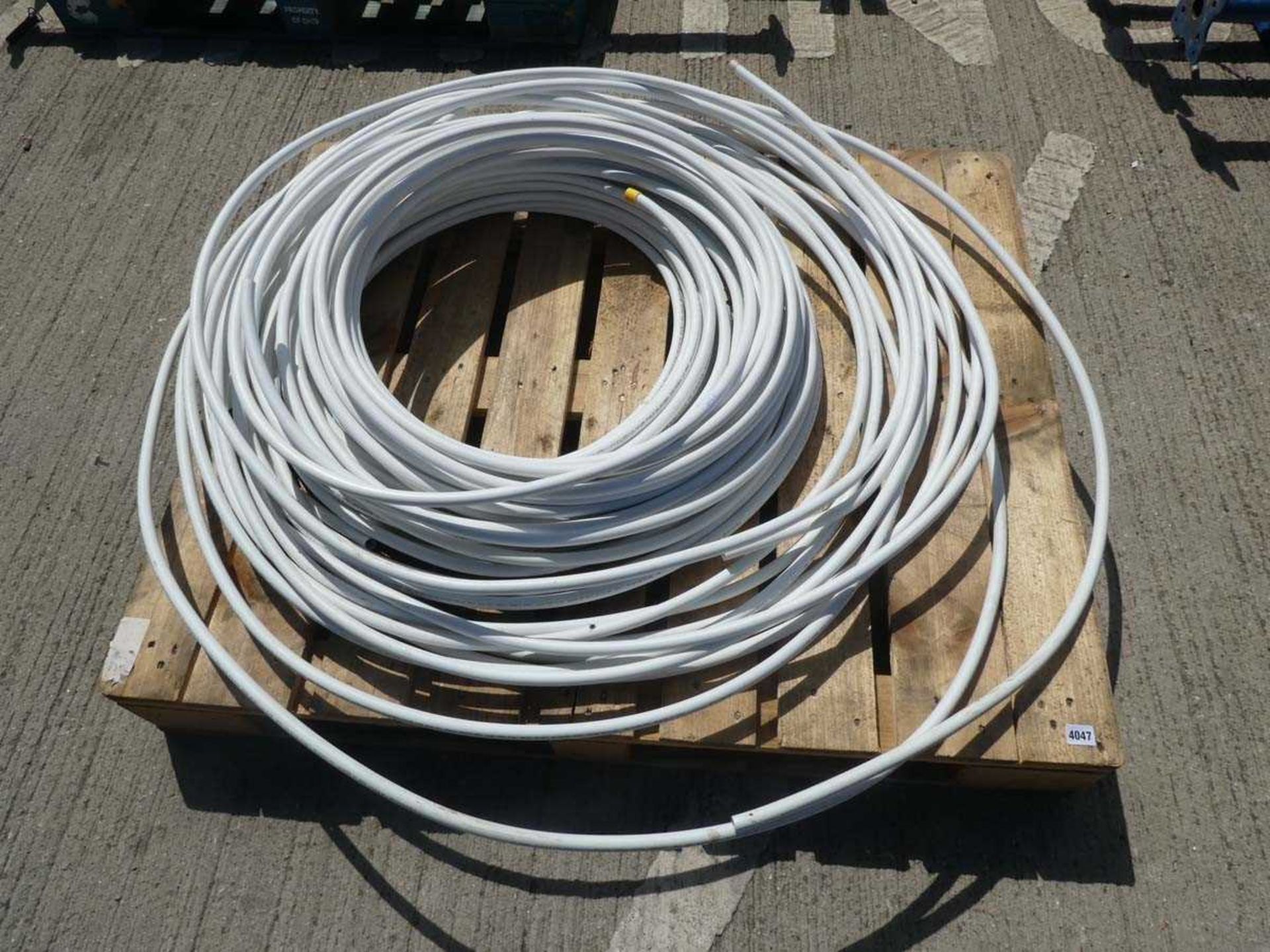 Pallet containing a large quantity of white plastic pipe
