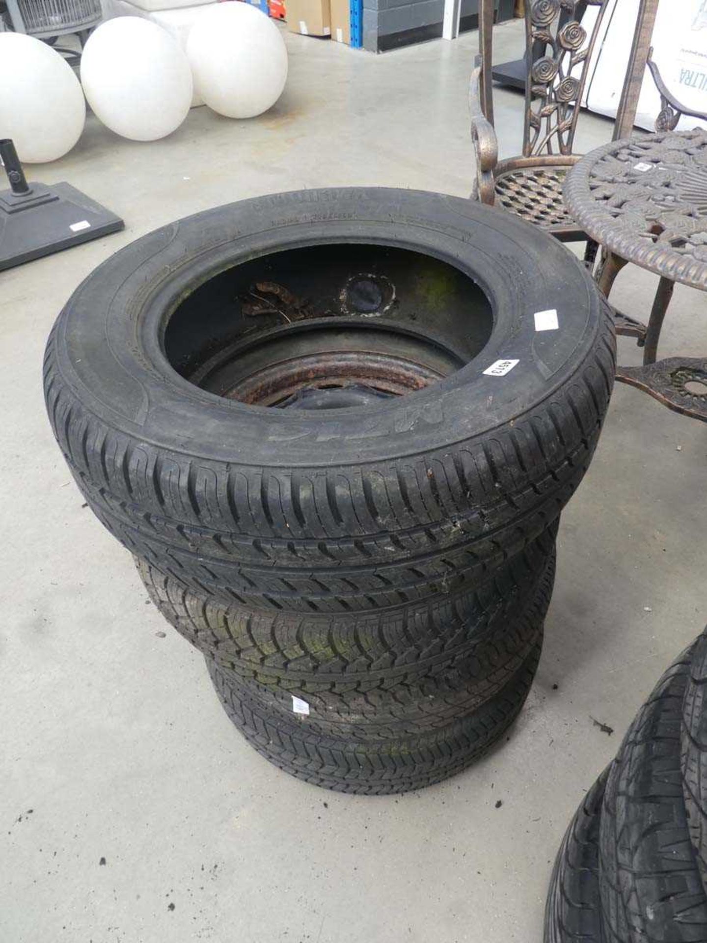 Stack of 3 wheels with tyres and 1 spare tyre