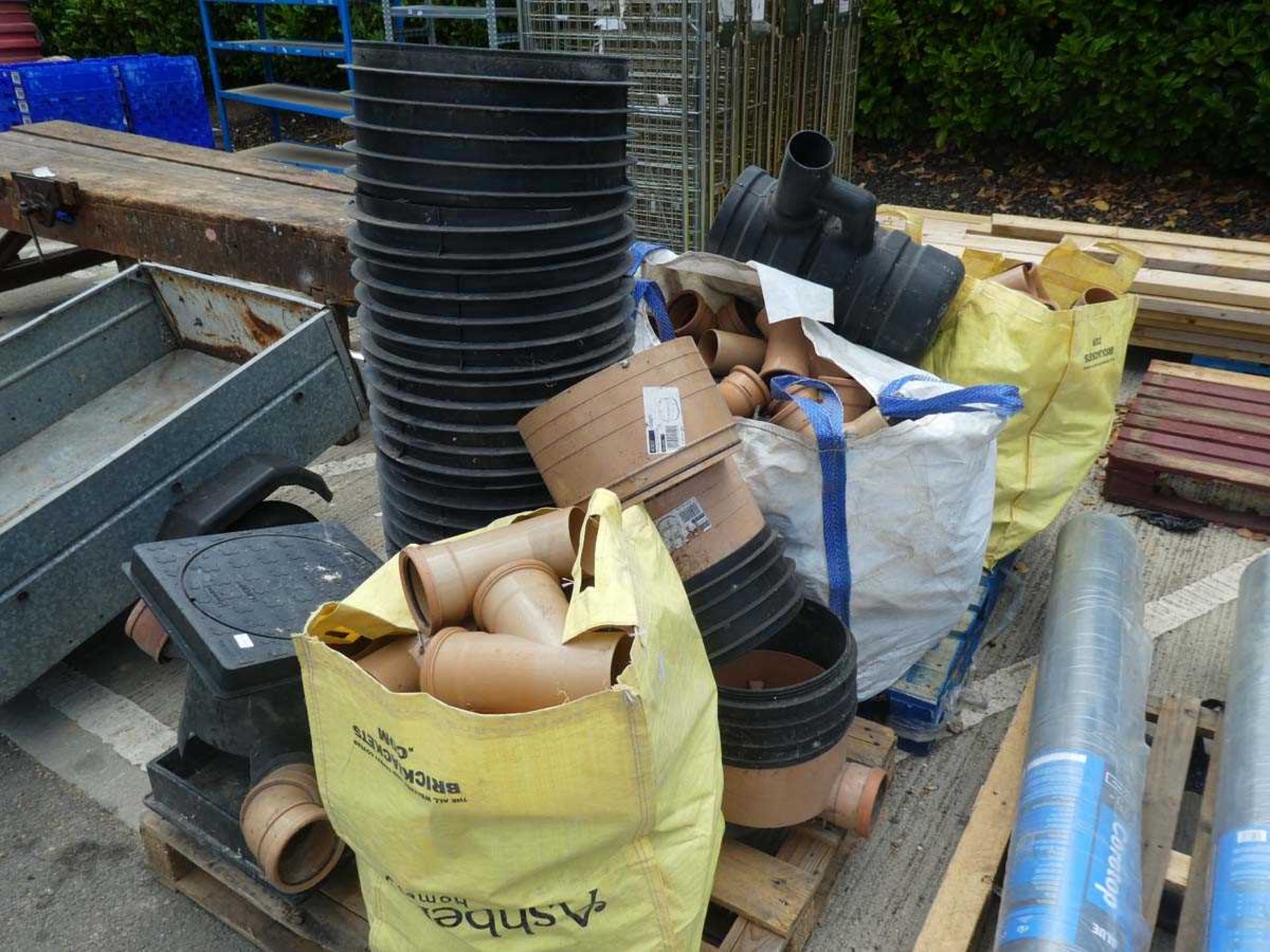 Two pallets containing a large quantity of various drainage fixtures containing within builder's