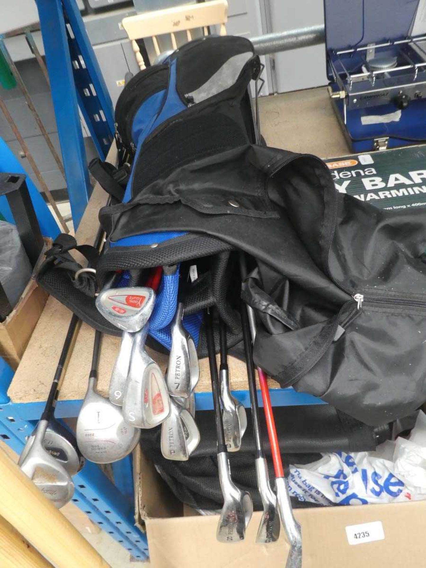 Blue & black Petron golf bag and contents of various irons