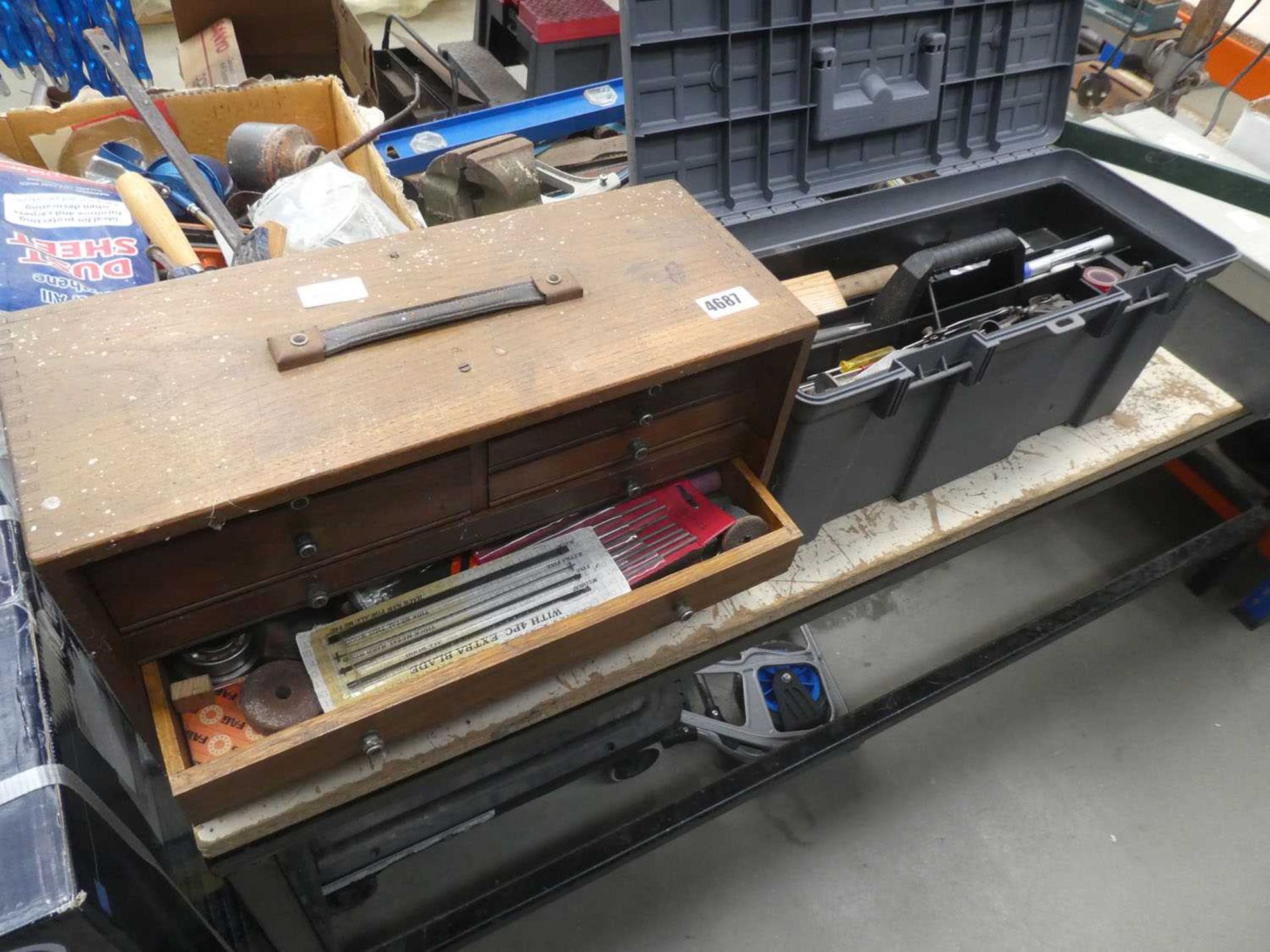 Wooden toolbox and plastic toolbox containing various engineering tools