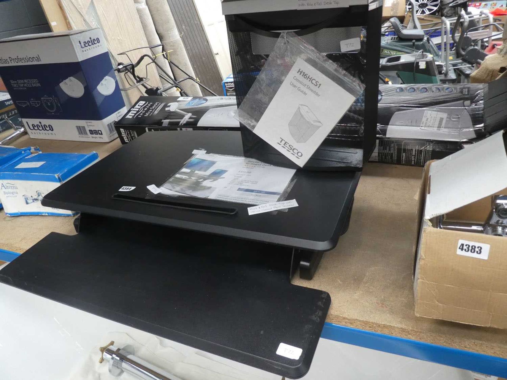 Desk riser and a small paper shredder