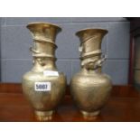 Pair of oriental brass dragon decorated vases