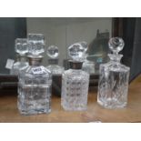 Two silver mounted decanters and an Edinburgh crystal decanter, max h. 25 cm (3)