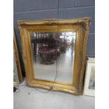 Rectangular bevelled mirror in decorative gilt frame